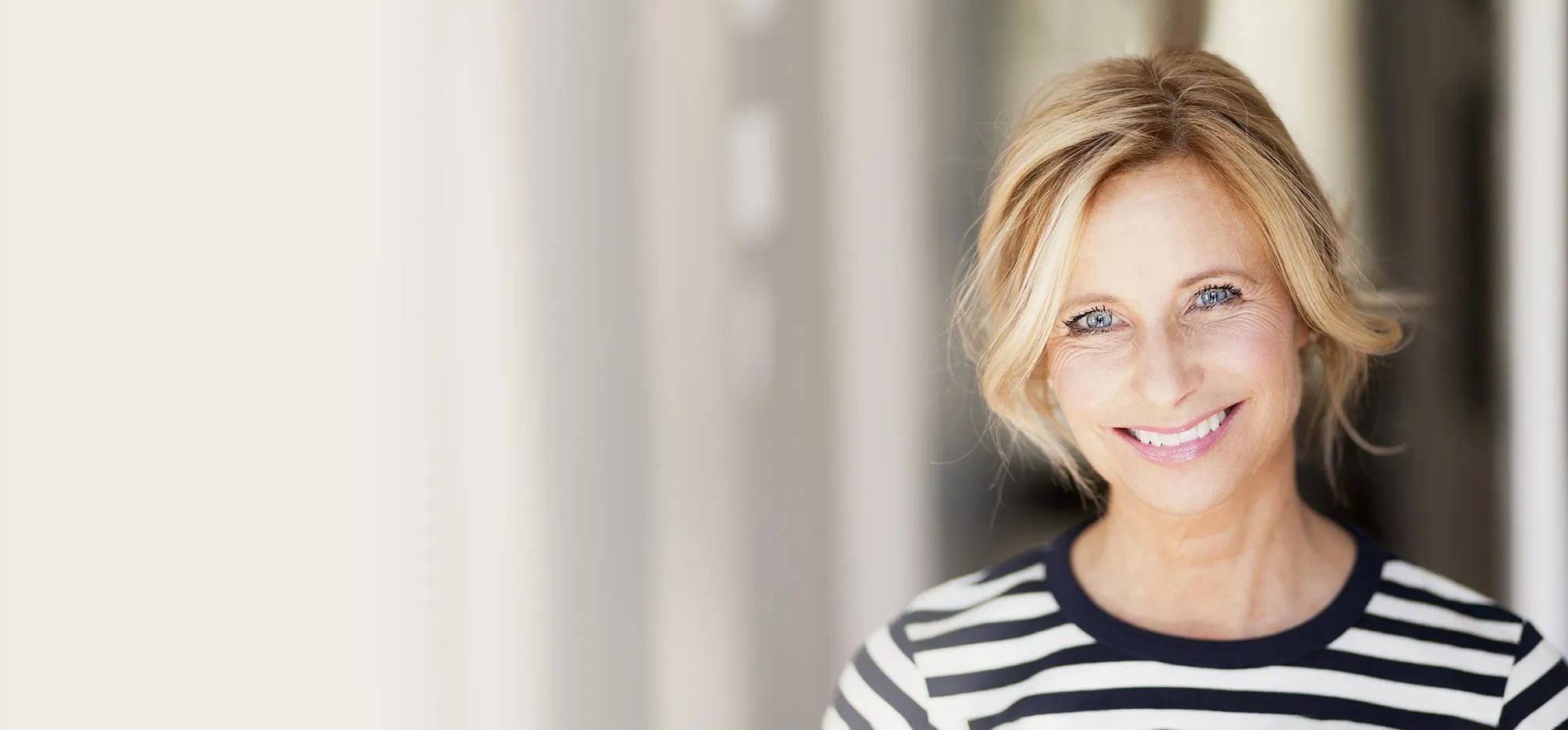 Smiling blond woman with striped shirt